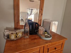 a counter top with a coffee maker and a microwave at Dee's Nest in Dingle