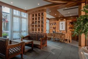 a dining room with chairs and a table and a counter at Lijiang Cloud Return Huiyi · On the Water Side Panoramic Hidden Inn (South Gate Mufu Branch) in Lijiang