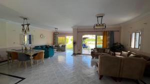 a living room with a couch and a table at Caribiano villa-3 in Dawwār Ḩalīs