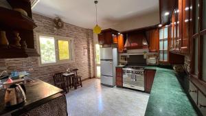 a kitchen with a refrigerator and a table in it at Caribiano villa-3 in Dawwār Ḩalīs