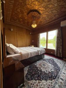 a bedroom with a bed in a room with a rug at Lord Palace Houseboat in Srinagar +7 photos