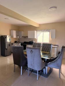 a kitchen with a table and chairs and a refrigerator at Edificio Ramírez 1 in Boca Canasta