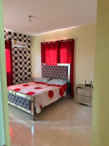 a bedroom with a bed and red curtains at Edificio Ramírez 1 in Boca Canasta