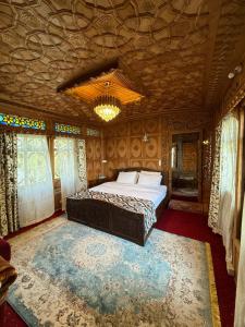 a bedroom with a large bed in a room at Lord Palace Houseboat in Srinagar