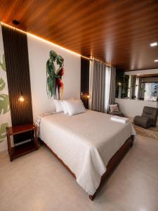 a bedroom with a large bed with a painting on the wall at Wiky House Guaduas in Guaduas +38 photos