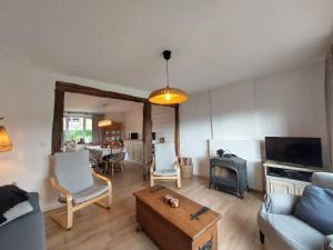a living room with a couch and a table at Ma maison de famille in Saint-Hubert