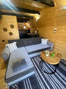 a living room with a couch and a table at Plivska vila 2 in Jajce