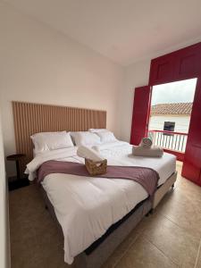 a bedroom with a large bed with a large window at El Portón de Salento in Salento