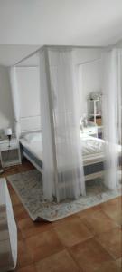 a bedroom with a bed with curtains on it at Bello horizonte in Coín