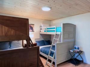 a bunk bed room with two bunk beds and a ladder at Pine Haven Tahoe-Cabin with Fire Pit, Grill & EV Charger in South Lake Tahoe