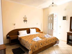 a bedroom with a large bed with two towels on it at Celestine Apartment, Arillas, Korfu in Arillas