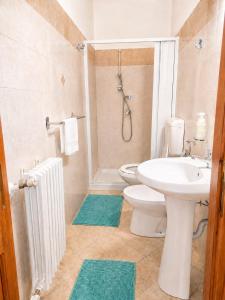 a bathroom with a sink and a toilet and a shower at Guglielmo room's B&B in Catania +22 photos