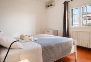 a white bed in a room with a window at Rooftop Madreperla in Taranto