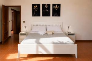 a bedroom with a white bed with two night stands at Rooftop Madreperla in Taranto