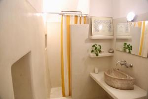 a bathroom with a sink and a shower at studio Barbouni in Aroniadika