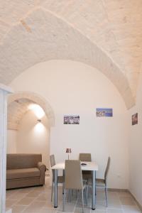 a living room with a table and a couch at Dimora Donizzetti in Martina Franca +17 photos