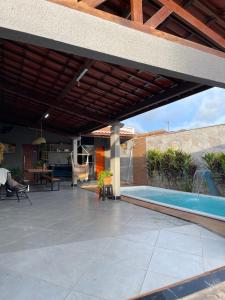 a patio with awning and a swimming pool at Casa Sol e mar in Tibau