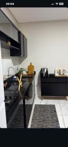 a kitchen with a black counter with a cross on it at Casa Sol e mar in Tibau