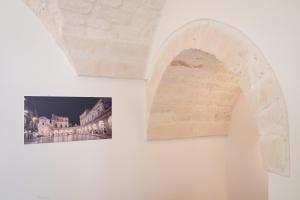 a picture and a picture of a building on a wall at Dimora Donizzetti in Martina Franca
