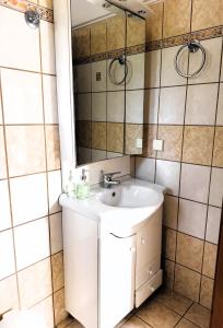 a bathroom with a sink and a mirror at Celestine Apartment, Arillas, Korfu in Arillas