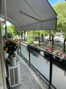 ein Balkon mit einem Sonnenschirm und Blumen darauf in der Unterkunft Da Ion in Marghera