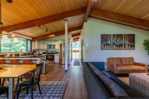 a living room with a long couch and a kitchen at Chasing Birdies in Beech Mountain