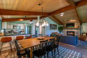 a dining room and living room with a wooden table and chairs at Chasing Birdies in Beech Mountain +38 photos