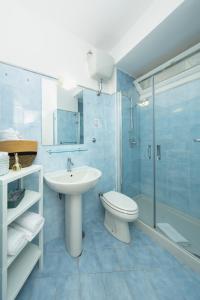 a bathroom with a sink and a toilet and a shower at Birago22Capri in Capri +24 photos