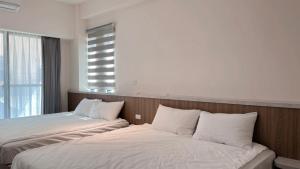 two beds sitting next to each other in a room at Musun Stay in Ch'ao-yang +5 photos