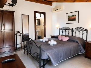 a bedroom with a large bed with pink pillows at Holiday Residence in Casamassima