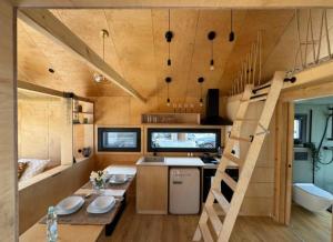 a small kitchen with a staircase in a tiny house at Tinyhouse am Bach, 3144 Wald in Wald