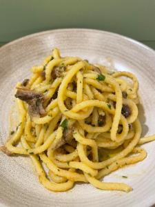 a plate of pasta on a white plate at Corte Impero Hotel & Restaurant in Affi