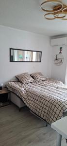 a bedroom with a large bed in a room at Vertige Bleu, Vue mer, Port, Plage, WI-FI, Clim, Centre ville, Commerces, Calme in La Grande Motte