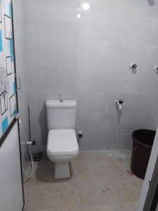 a bathroom with a white toilet in a stall at CaReville Chunnakam in Chunnakam