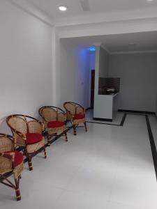 a group of chairs in a room with a table at CaReville Chunnakam in Chunnakam