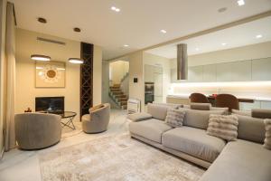 a living room with a white couch and chairs at Blue Coast-Vala Mar Villa in Hamallë