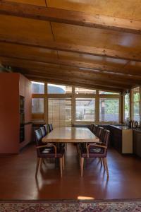 a dining room with a wooden table and chairs at Agriturismo Corte d'acqua in Abano Terme
