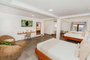 a bedroom with a bed and a living room at El Barranco Galapagos in Puerto Ayora