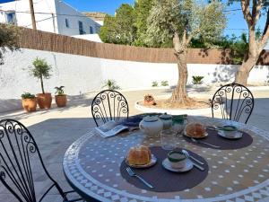 a table with food on it on a patio at El Olivo in Níjar