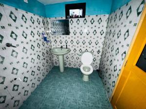 a bathroom with a toilet and a sink at The peace place in Ella