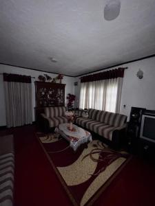 a living room with a couch and a table at The peace place in Ella