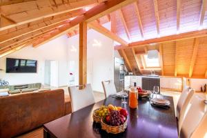a kitchen and dining room with a table with fruit on it at Ferienwohnung Bergele in Rot an der Rot