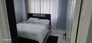 a small bed in a room with a window at The Amanda Bed & Breakfast in Migori