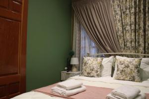 a bedroom with a bed with green walls and a window at Gravanis Resort in Sikáminon +48 photos