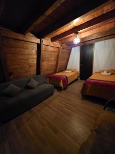 a room with two beds and a couch in it at Chalet Cuarzo in Mineral del Chico
