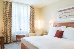 a hotel room with a bed and a window at Radisson Blu Ridzene Hotel, Riga in Riga +50 photos