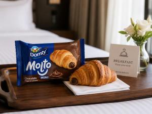 a tray with two croissants and a bag of mocha milk at Nile View Studio Aswan in Aswan