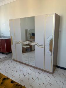 a bathroom with a sliding glass door in a room at Modern studio apartment in Mogadishu