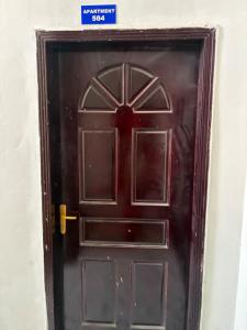 a brown door with a sign on top of it at Modern studio apartment in Mogadishu