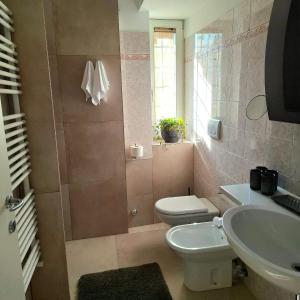 a bathroom with a toilet and a sink at Casa Ewa in Fiavè